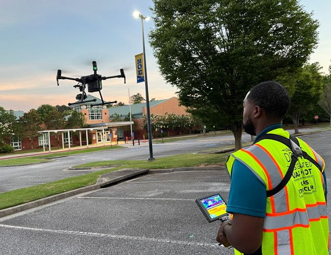 worker flying a drone